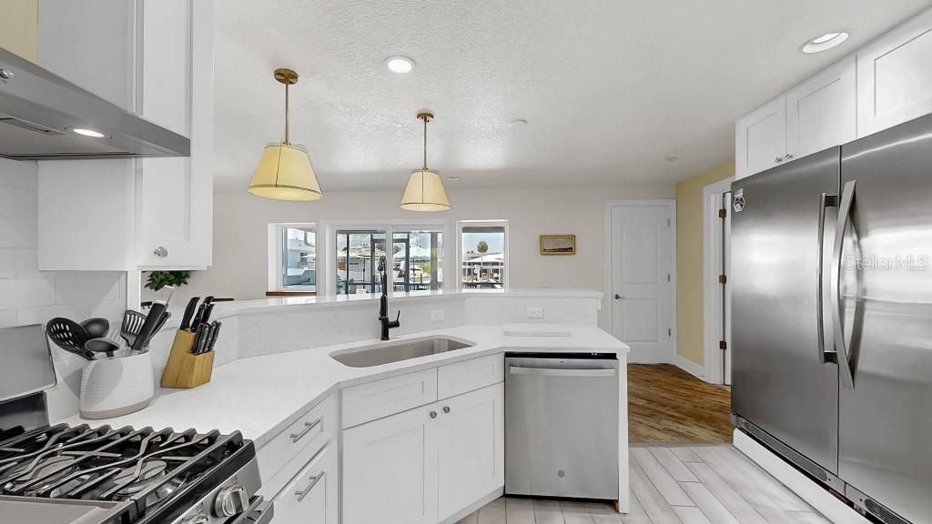 1004 Sago Palm Way Apollo Beach, FL 33572 - Photo 6 of 25 a kitchen with stainless steel appliances a sink a stove a refrigerator and cabinets