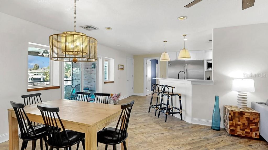 1004 Sago Palm Way Apollo Beach, FL 33572 - Photo 9 of 25 a view of a dining room with furniture and chandelier