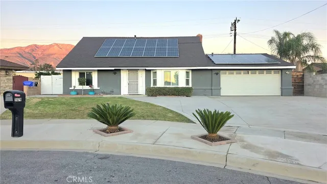 a front view of a house with a yard and a garage