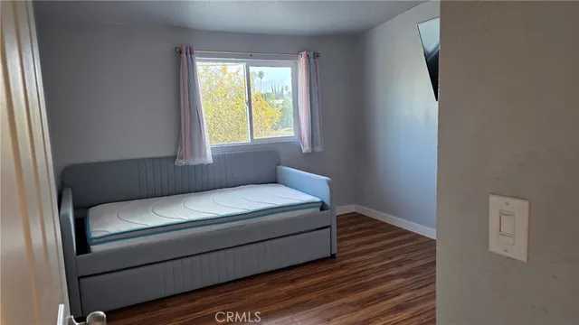 a living room with a bed and a window
