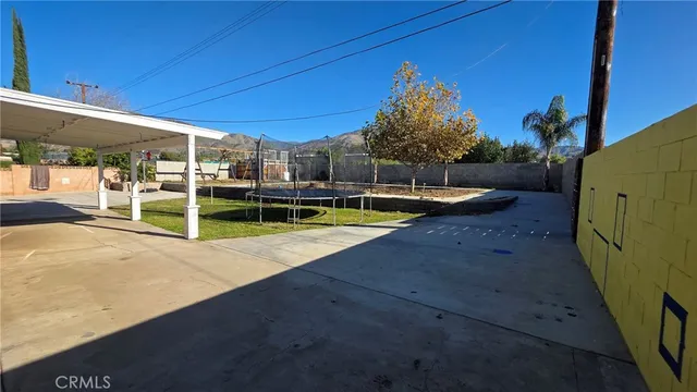 a view of a backyard with swimming pool