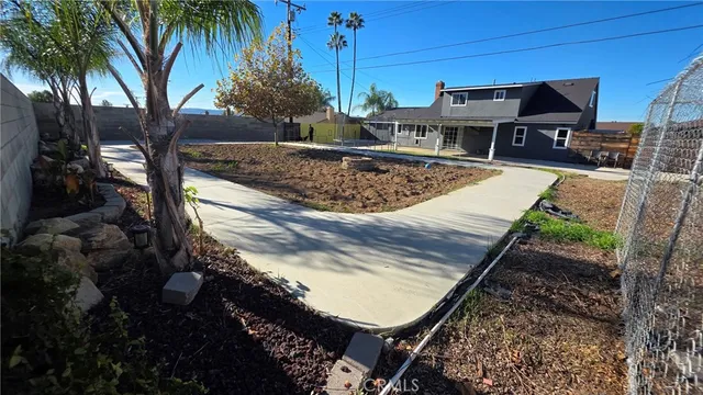 a view of a swimming pool with a patio and a yard