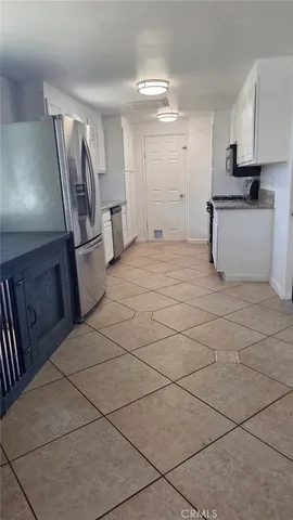 a kitchen with stainless steel appliances a refrigerator sink and cabinets