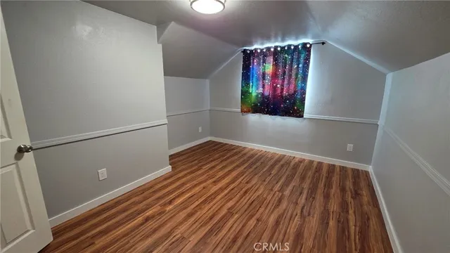a view of staircase with wooden floor and chandelier