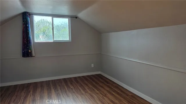 a view of a small space with wooden floor and windows