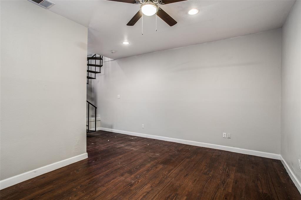 5114 Bryan Street, Unit 3 Dallas, TX 75206 - Photo 11 of 22 an empty room with wooden floor chandelier fan and closet