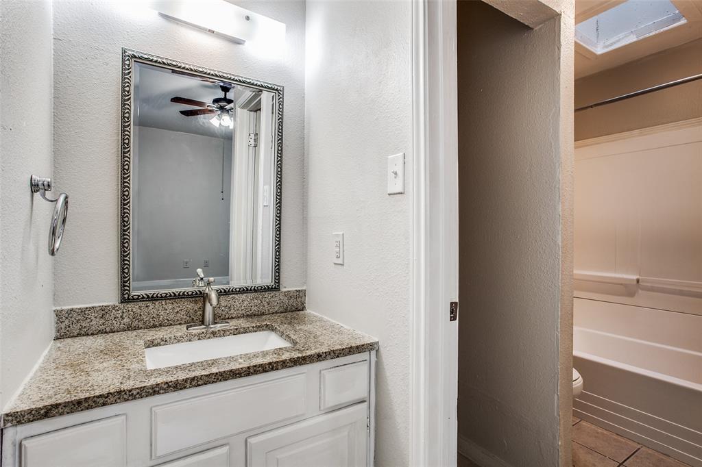 5114 Bryan Street, Unit 3 Dallas, TX 75206 - Photo 21 of 22 a bathroom with a granite countertop sink and a mirror