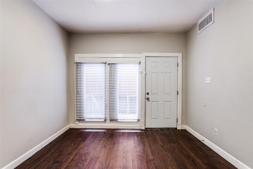 5114 Bryan Street, Unit 3 Dallas, TX 75206 - Photo 7 of 22 an empty room with wooden floor and windows