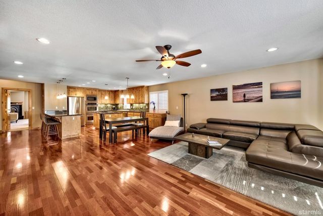 a living room with furniture and view of kitchen