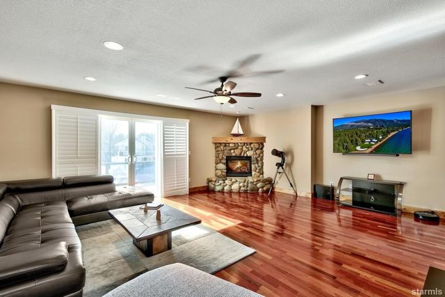 a living room with furniture and a flat screen tv with wooden floor