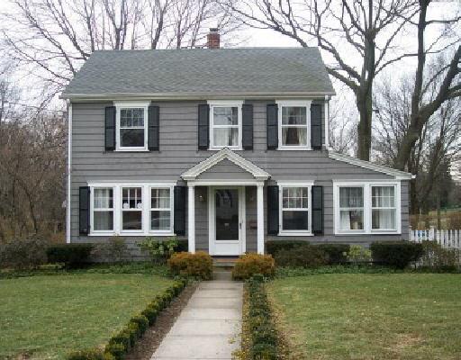 141 Edge Hill Road Fairfield, CT 06824 - Photo 1 of 1 a view of a brick house with a yard plants and large trees