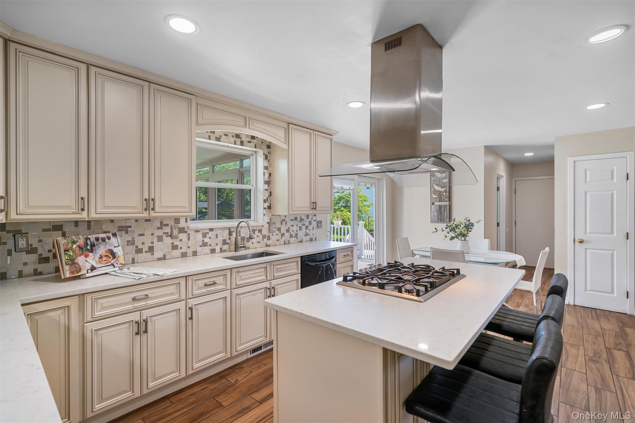 36 Lexington Drive Newburgh, NY 12550 - Photo 12 of 50 Kitchen with cream cabinets, a sink, island exhaust hood, decorative backsplash, and recessed lighting