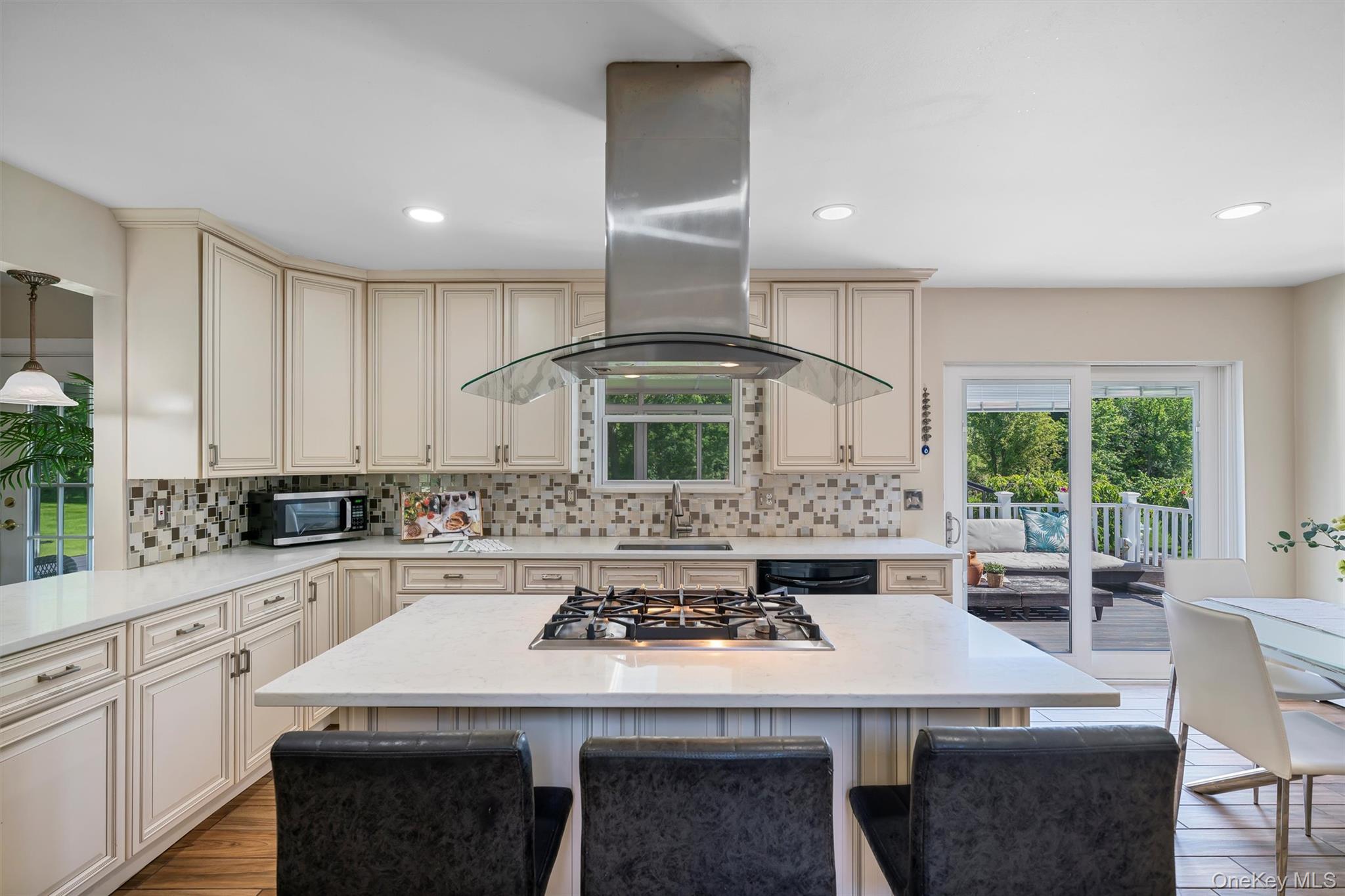 36 Lexington Drive Newburgh, NY 12550 - Photo 13 of 50 Kitchen with cream cabinetry, island exhaust hood, stainless steel appliances, a sink, and decorative backsplash