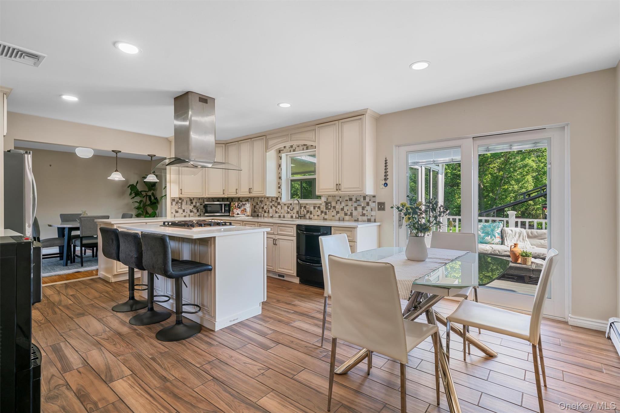 36 Lexington Drive Newburgh, NY 12550 - Photo 18 of 50 Kitchen featuring extractor fan, stainless steel appliances, light countertops, backsplash, and a center island