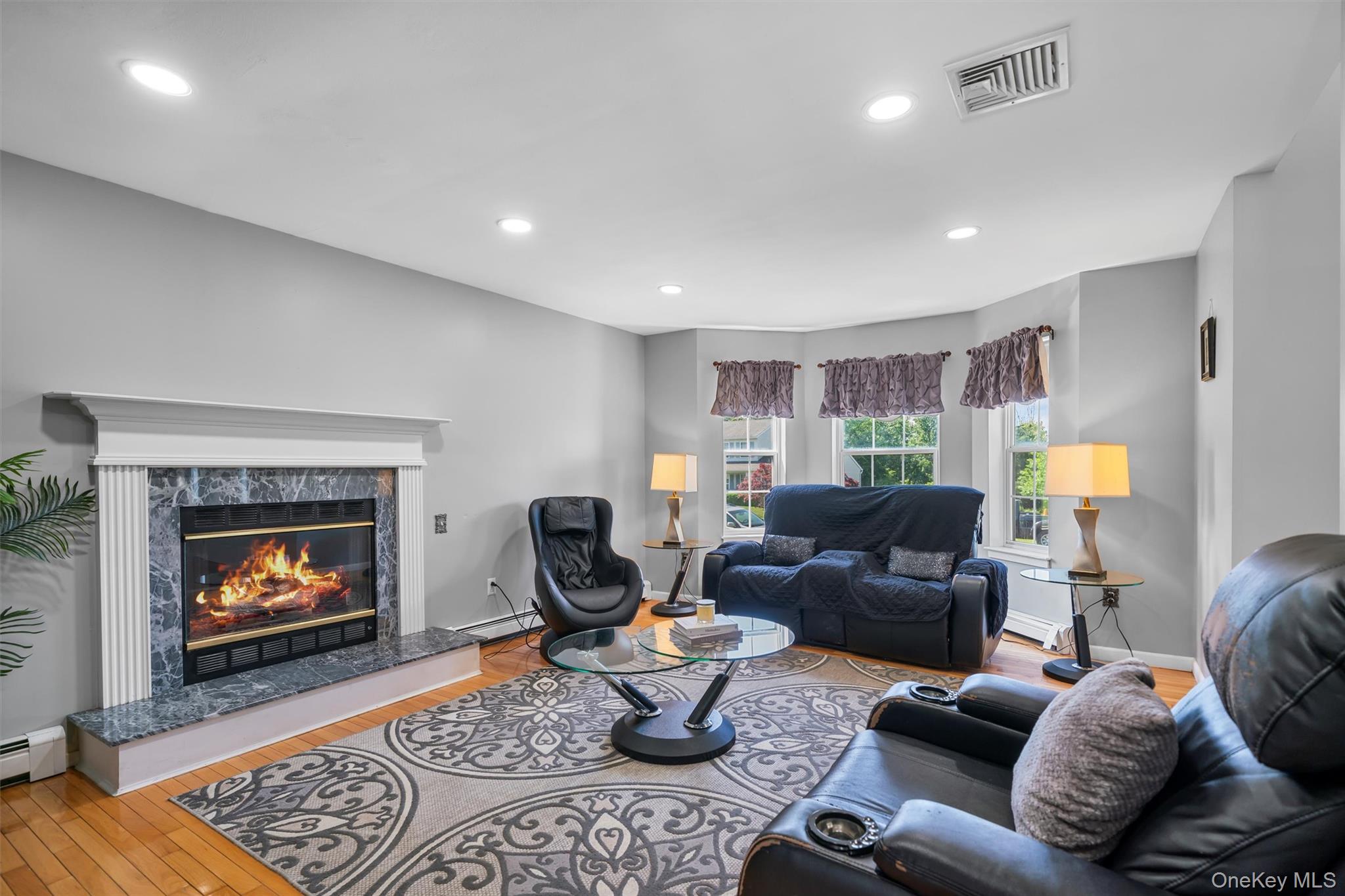 36 Lexington Drive Newburgh, NY 12550 - Photo 21 of 50 Living area with wood finished floors, a fireplace, recessed lighting, a baseboard radiator, and baseboards