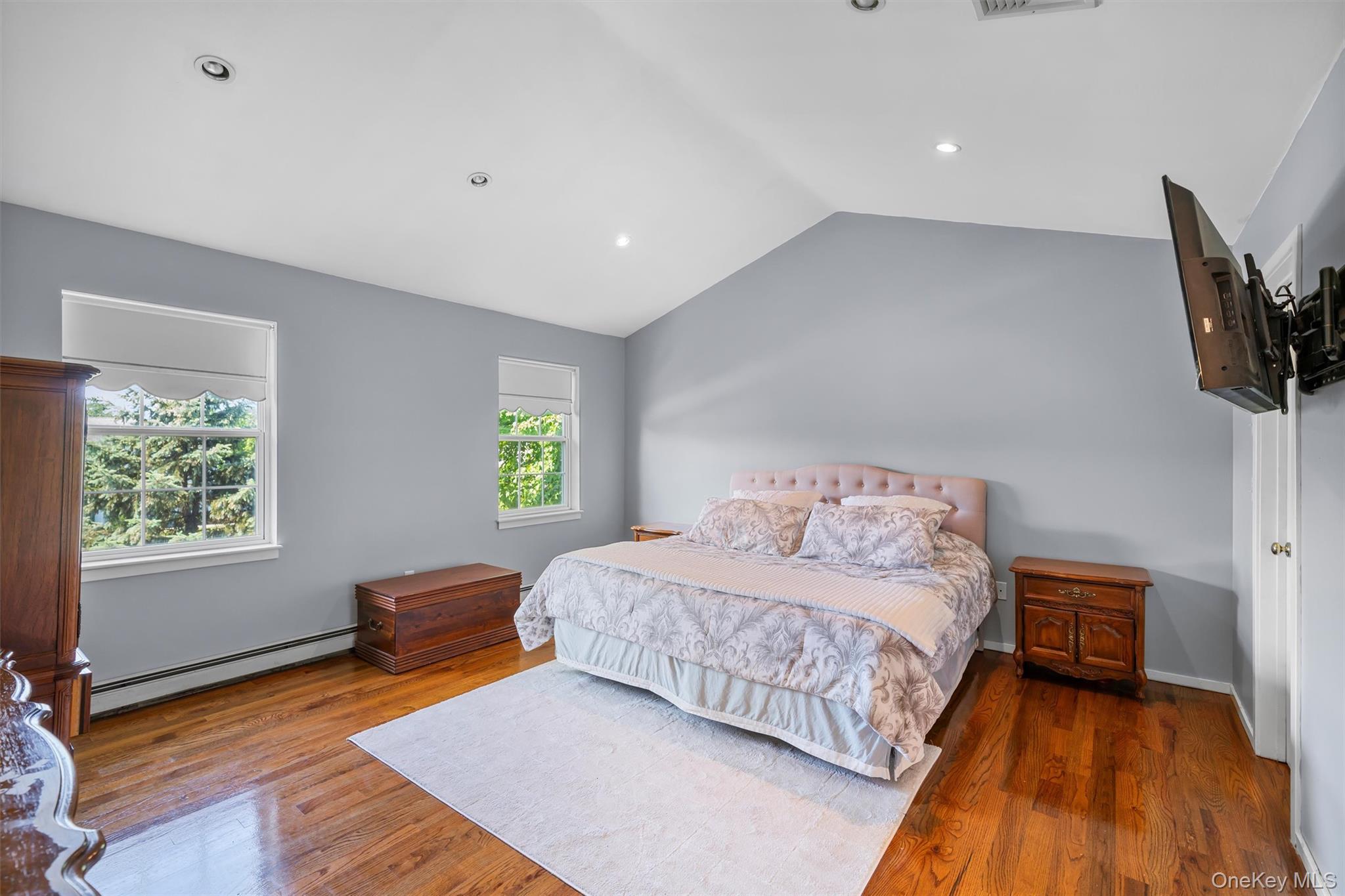 36 Lexington Drive Newburgh, NY 12550 - Photo 25 of 50 Bedroom featuring baseboard heating, vaulted ceiling, wood finished floors, and recessed lighting