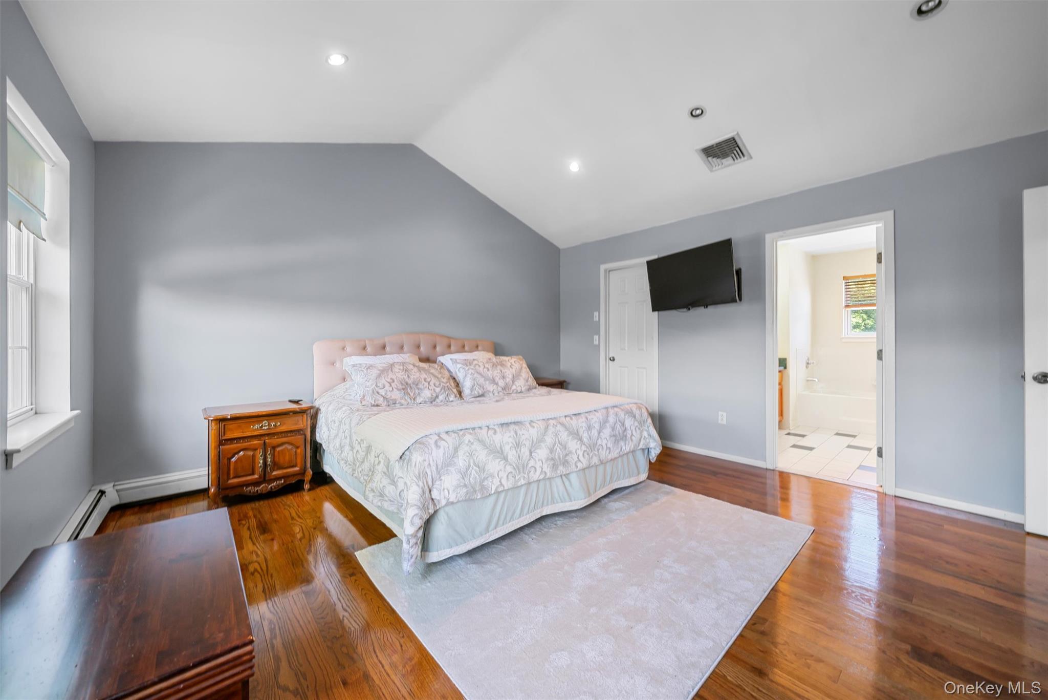 36 Lexington Drive Newburgh, NY 12550 - Photo 26 of 50 Bedroom with wood finished floors, vaulted ceiling, baseboard heating, baseboards, and recessed lighting