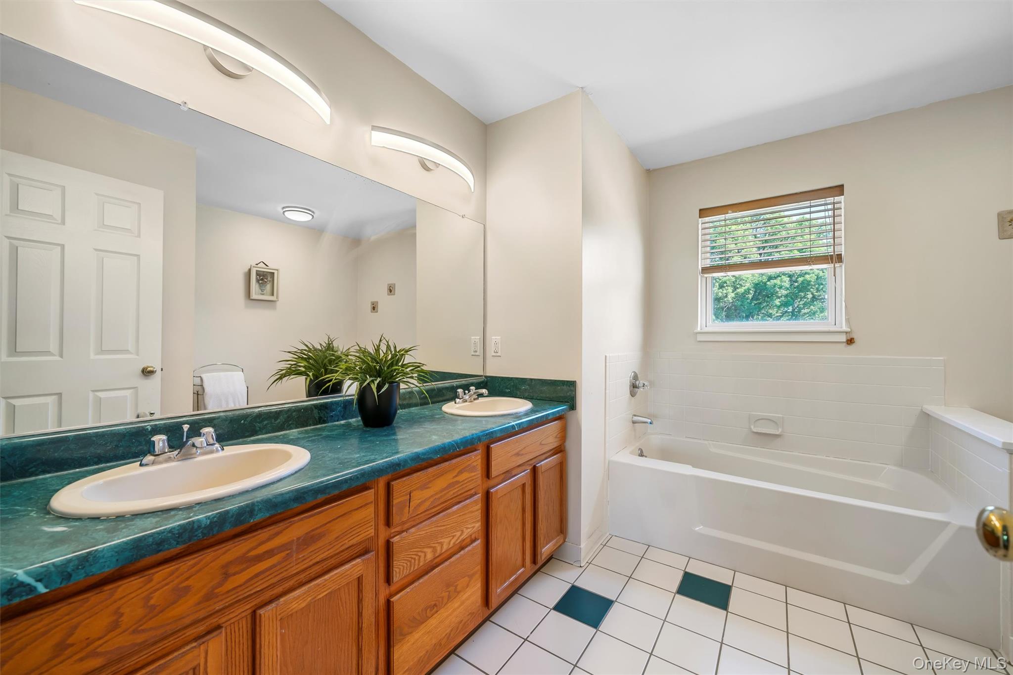 36 Lexington Drive Newburgh, NY 12550 - Photo 27 of 50 Bathroom featuring a garden tub, double vanity, and tile patterned floors