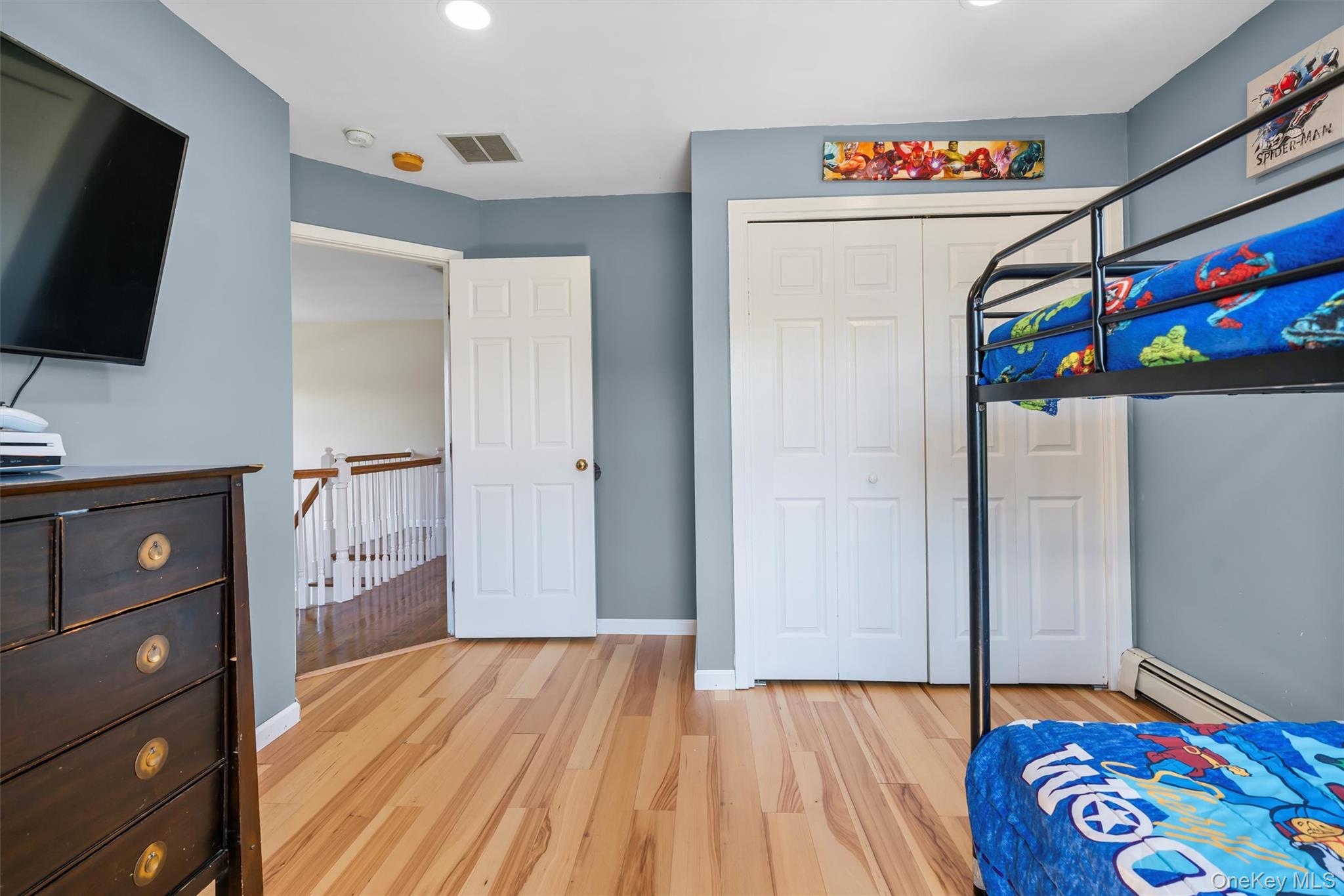 36 Lexington Drive Newburgh, NY 12550 - Photo 33 of 50 Bedroom featuring a baseboard radiator, light wood-style floors, a closet, and baseboards