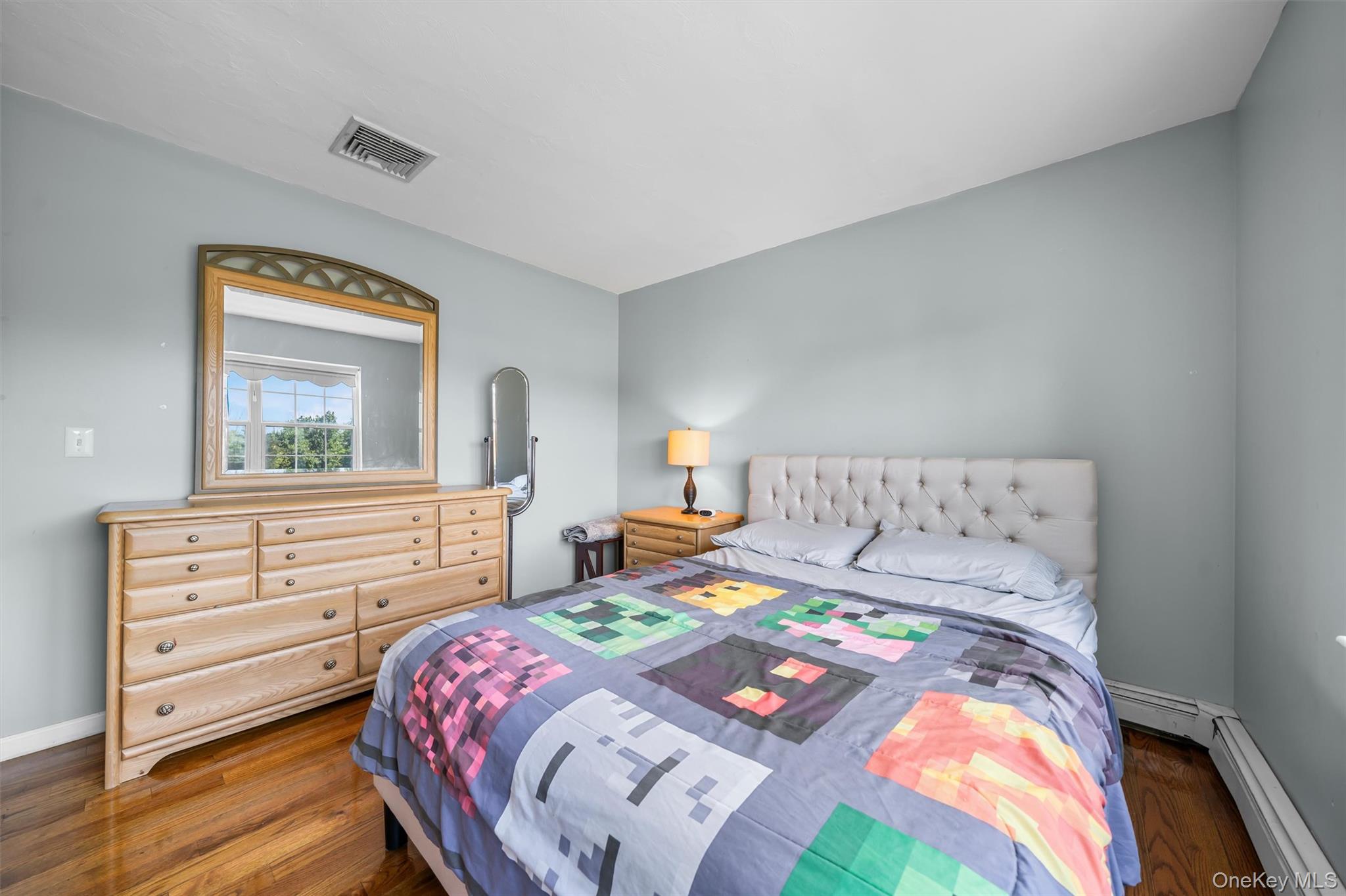 36 Lexington Drive Newburgh, NY 12550 - Photo 35 of 50 Bedroom featuring a baseboard heating unit, wood finished floors, and baseboards
