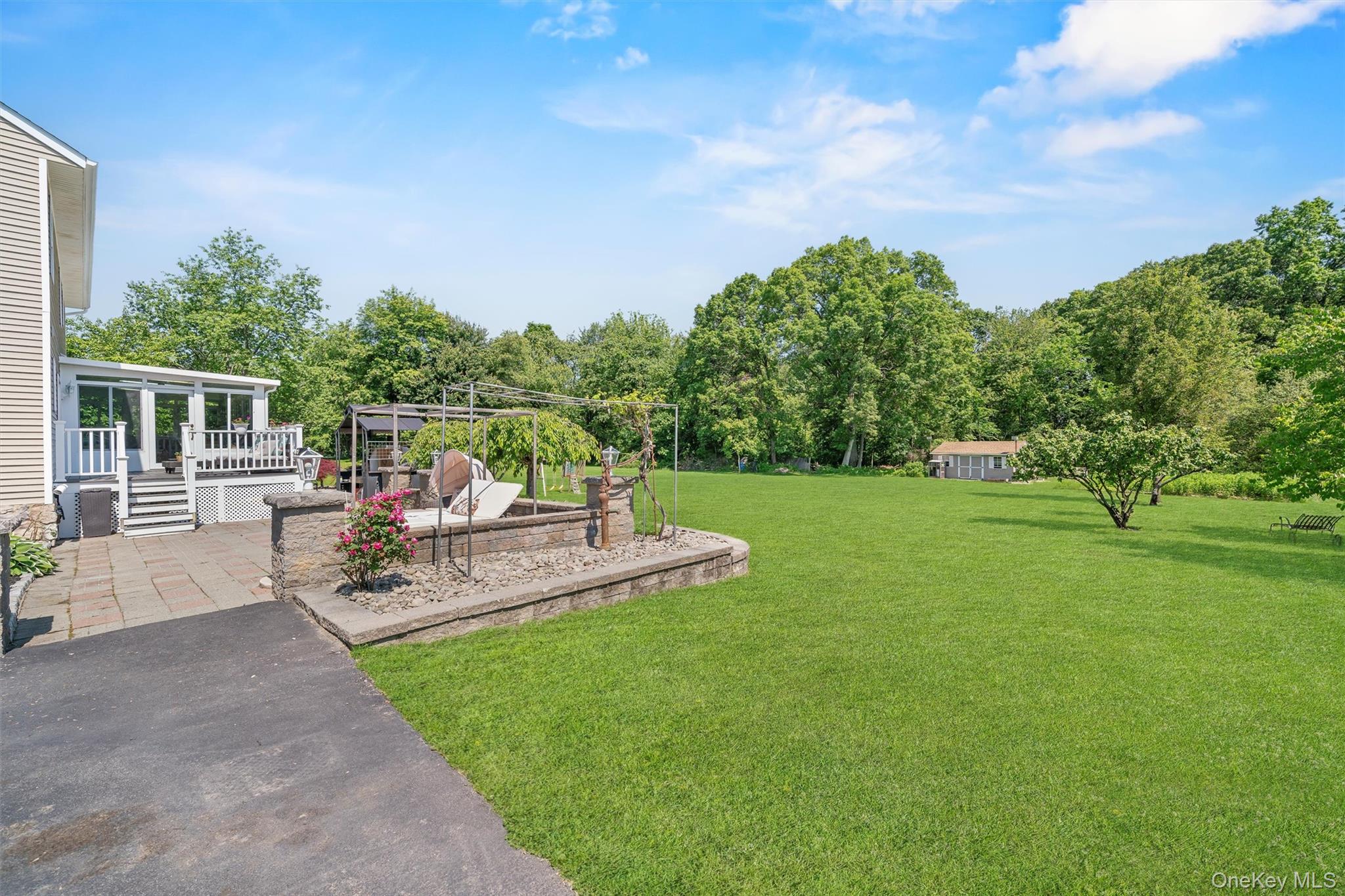 36 Lexington Drive Newburgh, NY 12550 - Photo 42 of 50 View of grassy yard featuring a patio area, view of scattered trees, a deck, and a sunroom