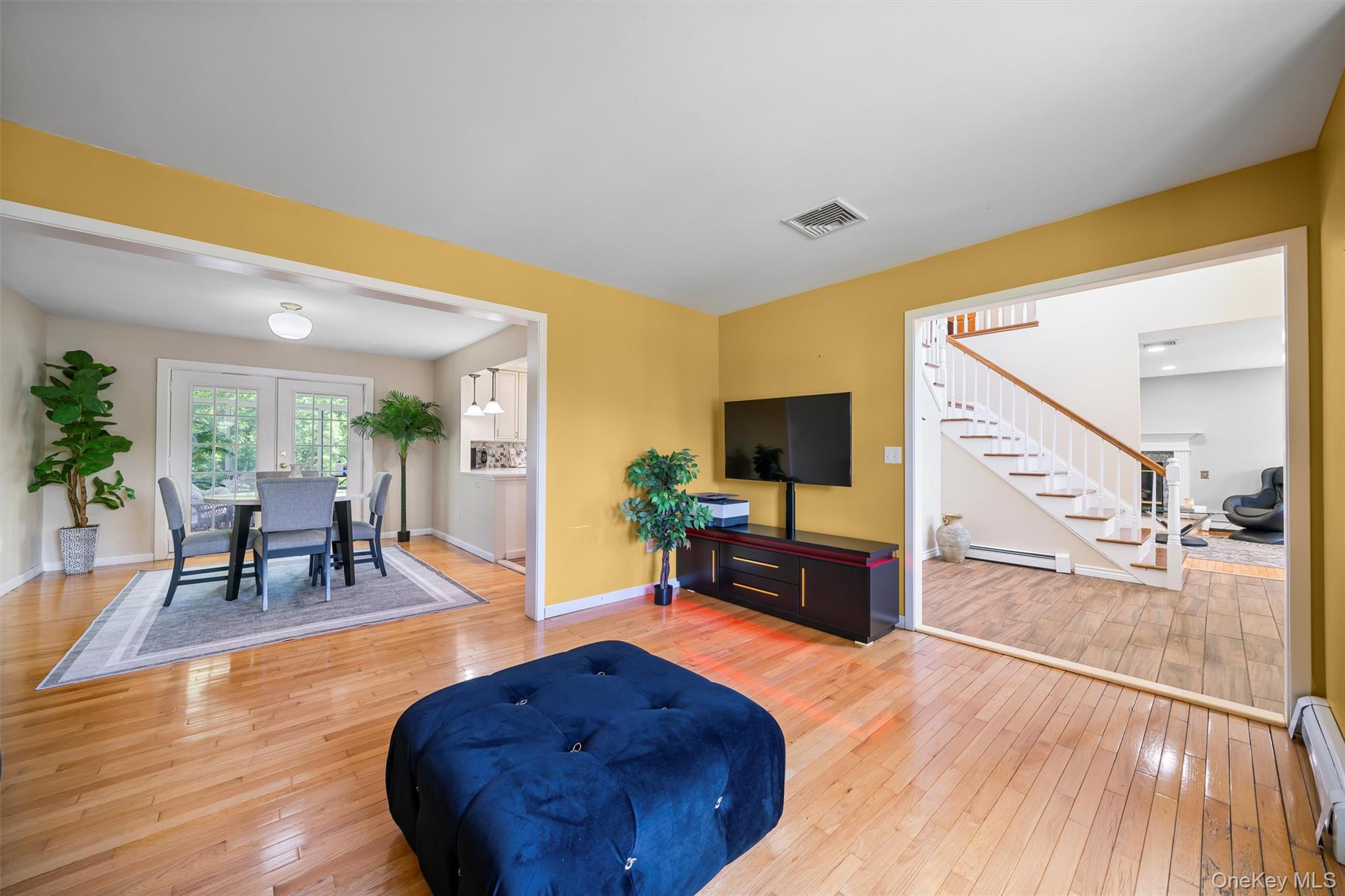 36 Lexington Drive Newburgh, NY 12550 - Photo 8 of 50 Living room featuring baseboard heating, stairway, wood-type flooring, a baseboard radiator, and baseboards