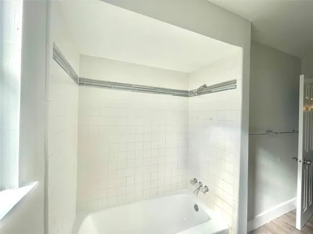 a bathroom with a bathtub and a shower