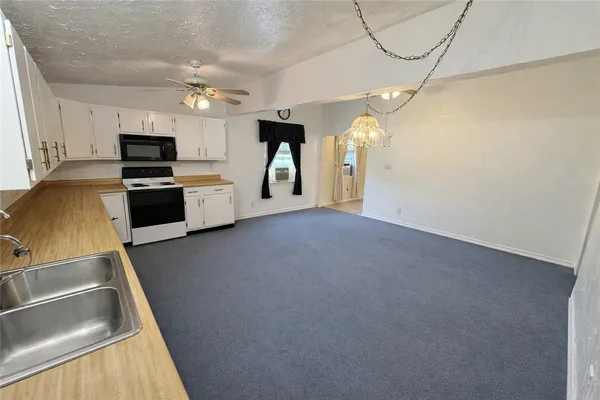 a view of kitchen with sink and cabinets