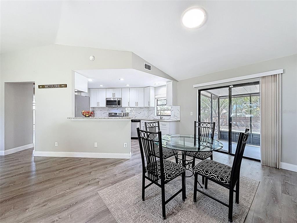 5384 Baldock Avenue Spring Hill, FL 34608 - Photo 17 of 51 a view of a dining room with furniture and wooden floor