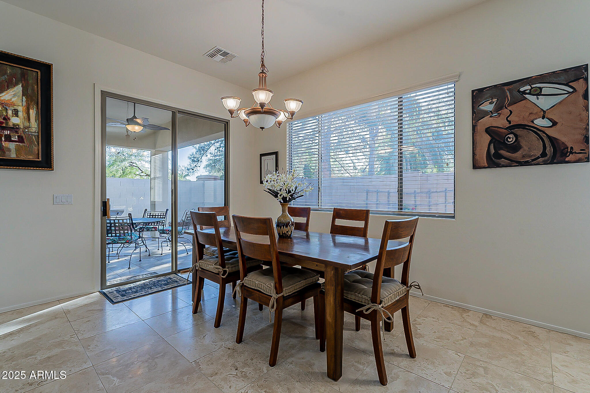 1857 West Periwinkle Way Chandler, AZ 85248 - Photo 13 of 38 a view of a dining room with furniture wooden floor and chandelier