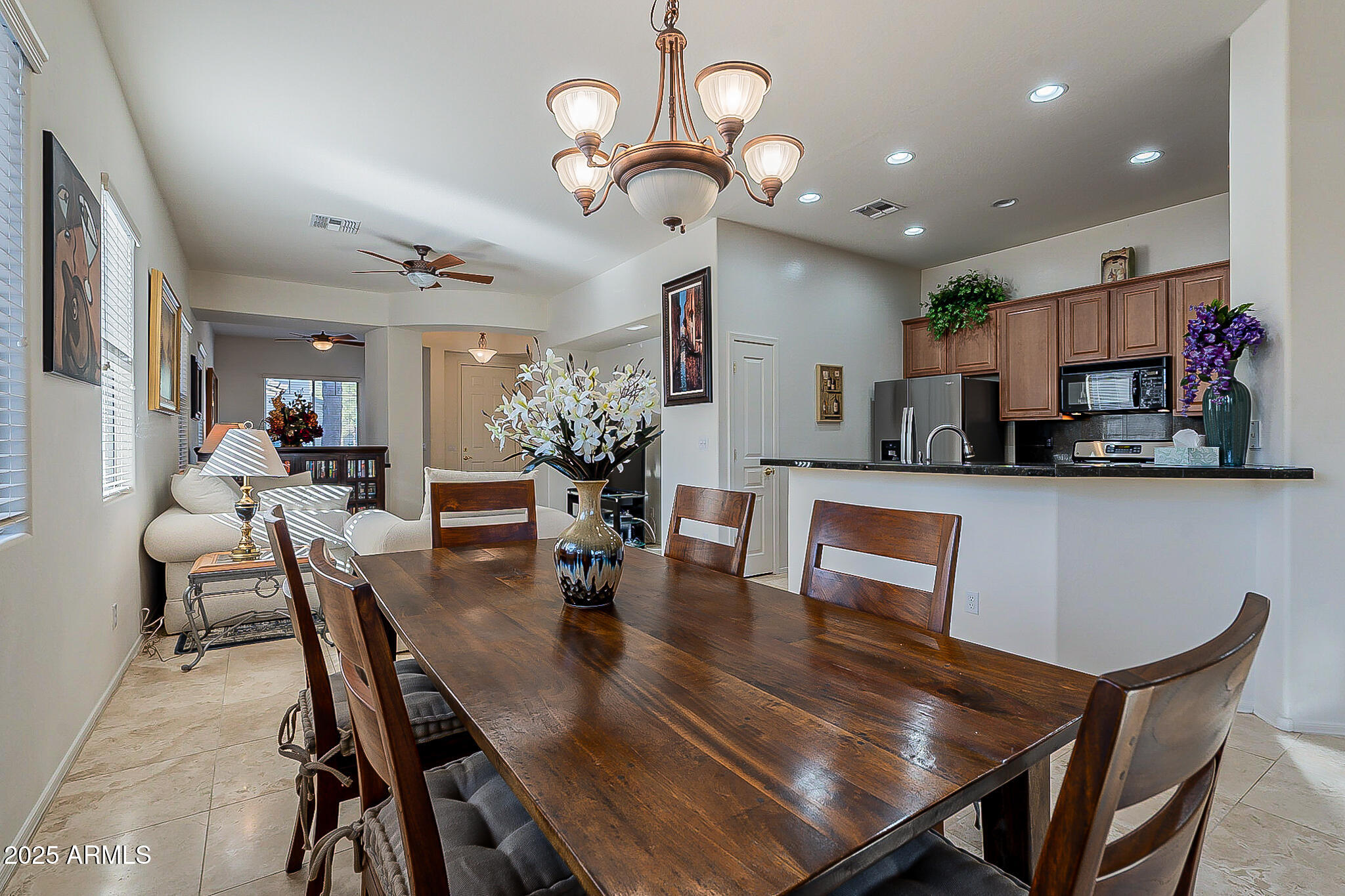 1857 West Periwinkle Way Chandler, AZ 85248 - Photo 16 of 38 a dining room filled chandelier and wooden furniture