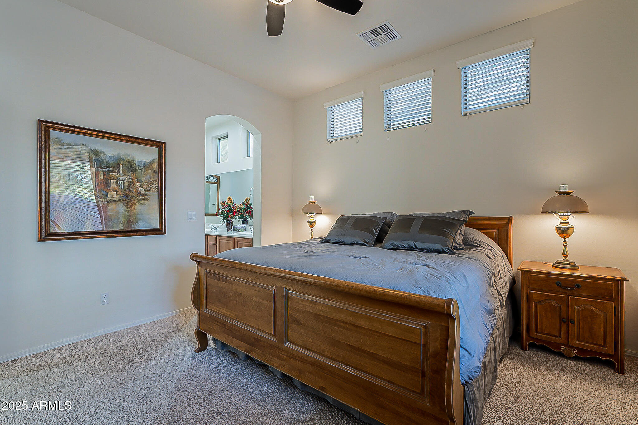 1857 West Periwinkle Way Chandler, AZ 85248 - Photo 21 of 38 a bedroom with a bed and a lamp on the dresser