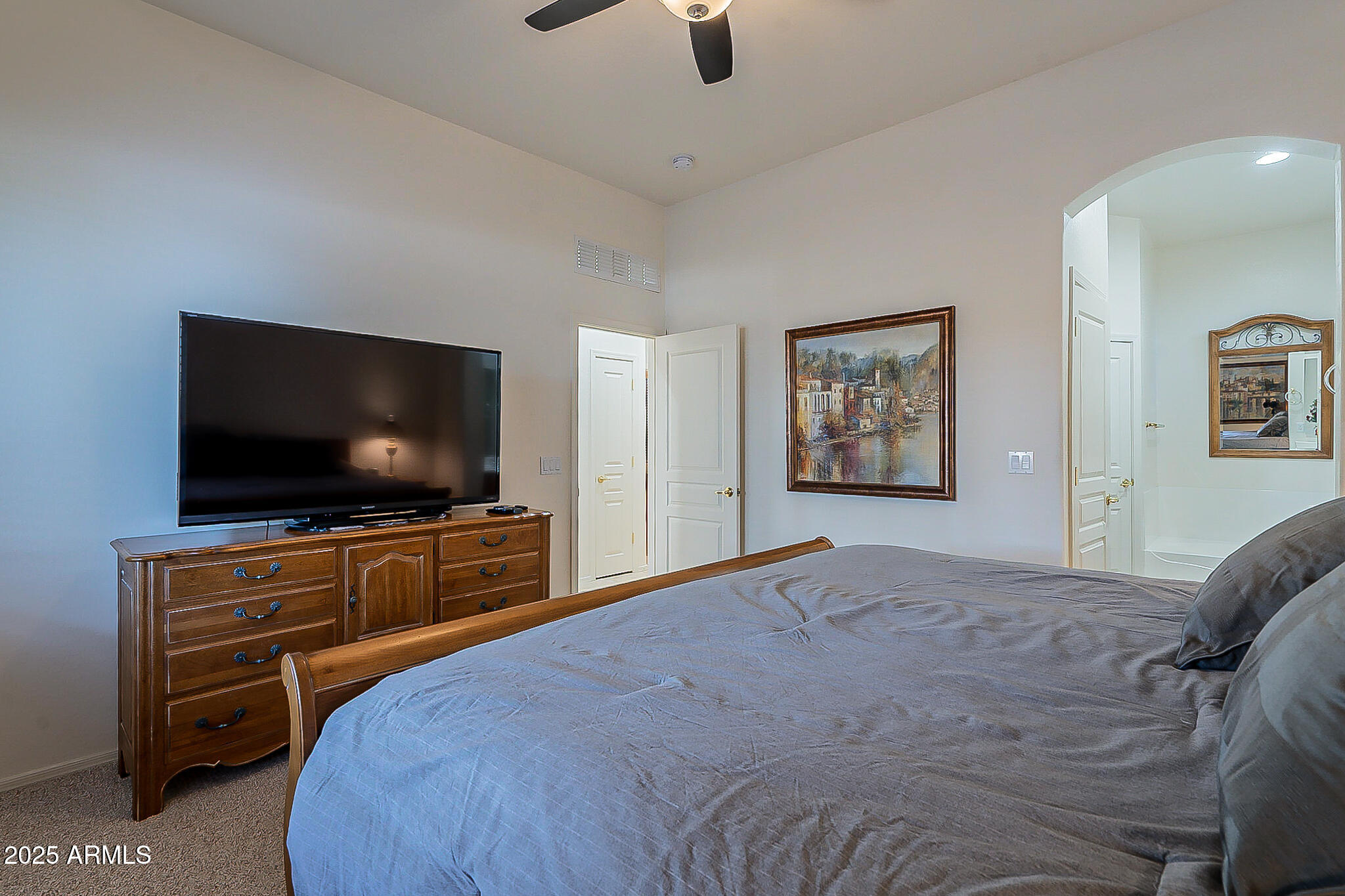 1857 West Periwinkle Way Chandler, AZ 85248 - Photo 23 of 38 a bedroom with a bed and a television in it