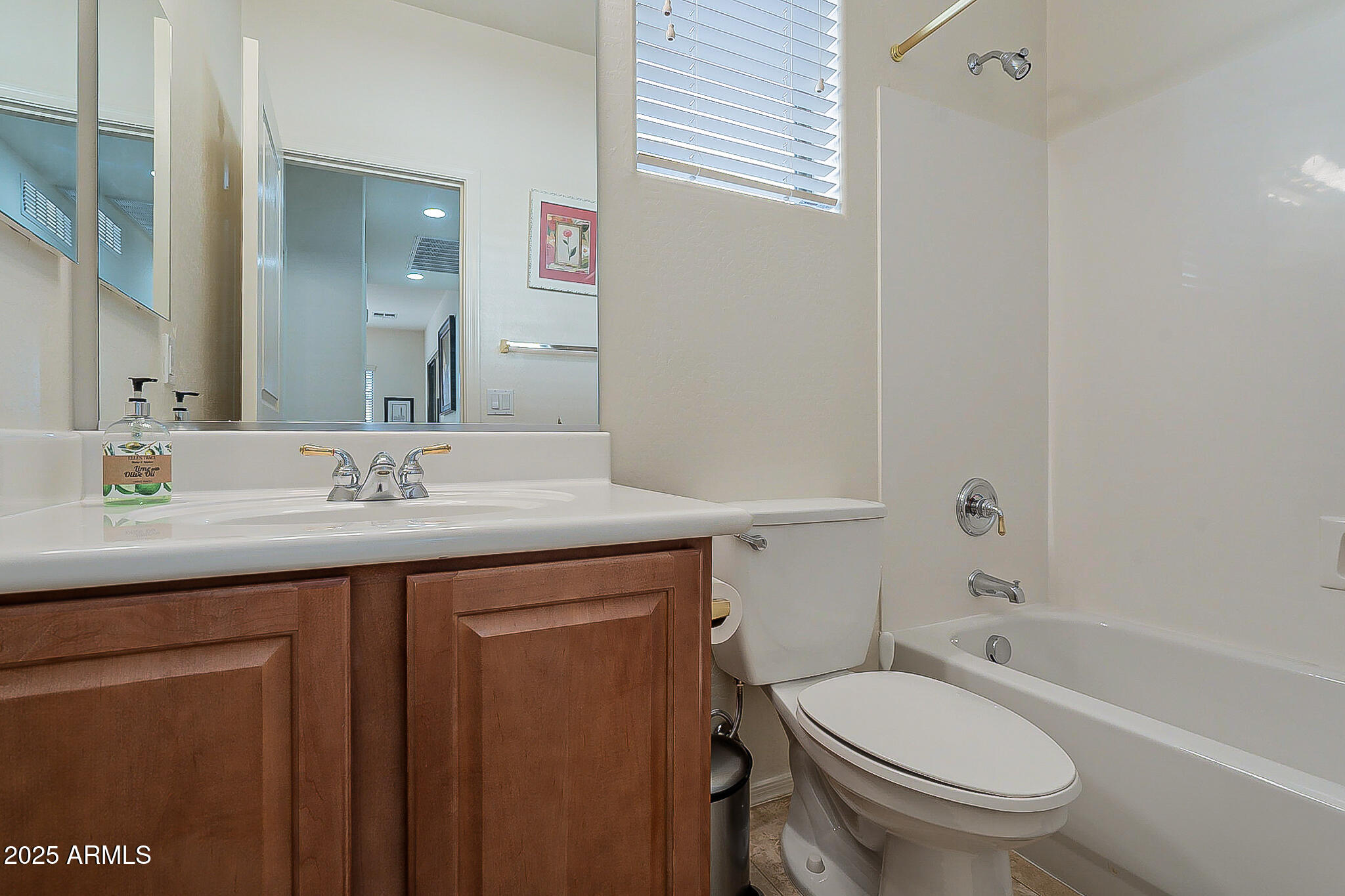 1857 West Periwinkle Way Chandler, AZ 85248 - Photo 30 of 38 a bathroom with a granite countertop toilet sink and mirror
