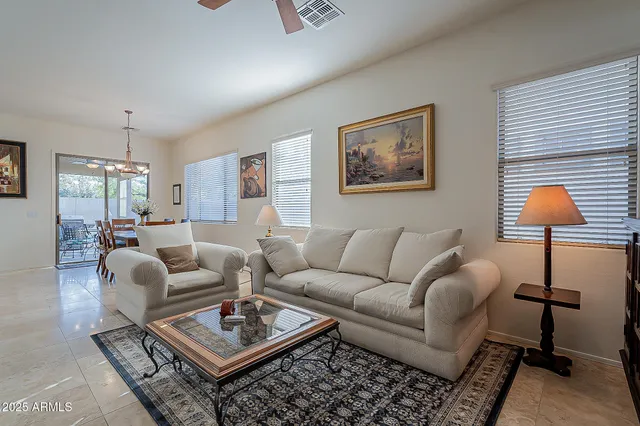 a living room with furniture a rug and a lamp