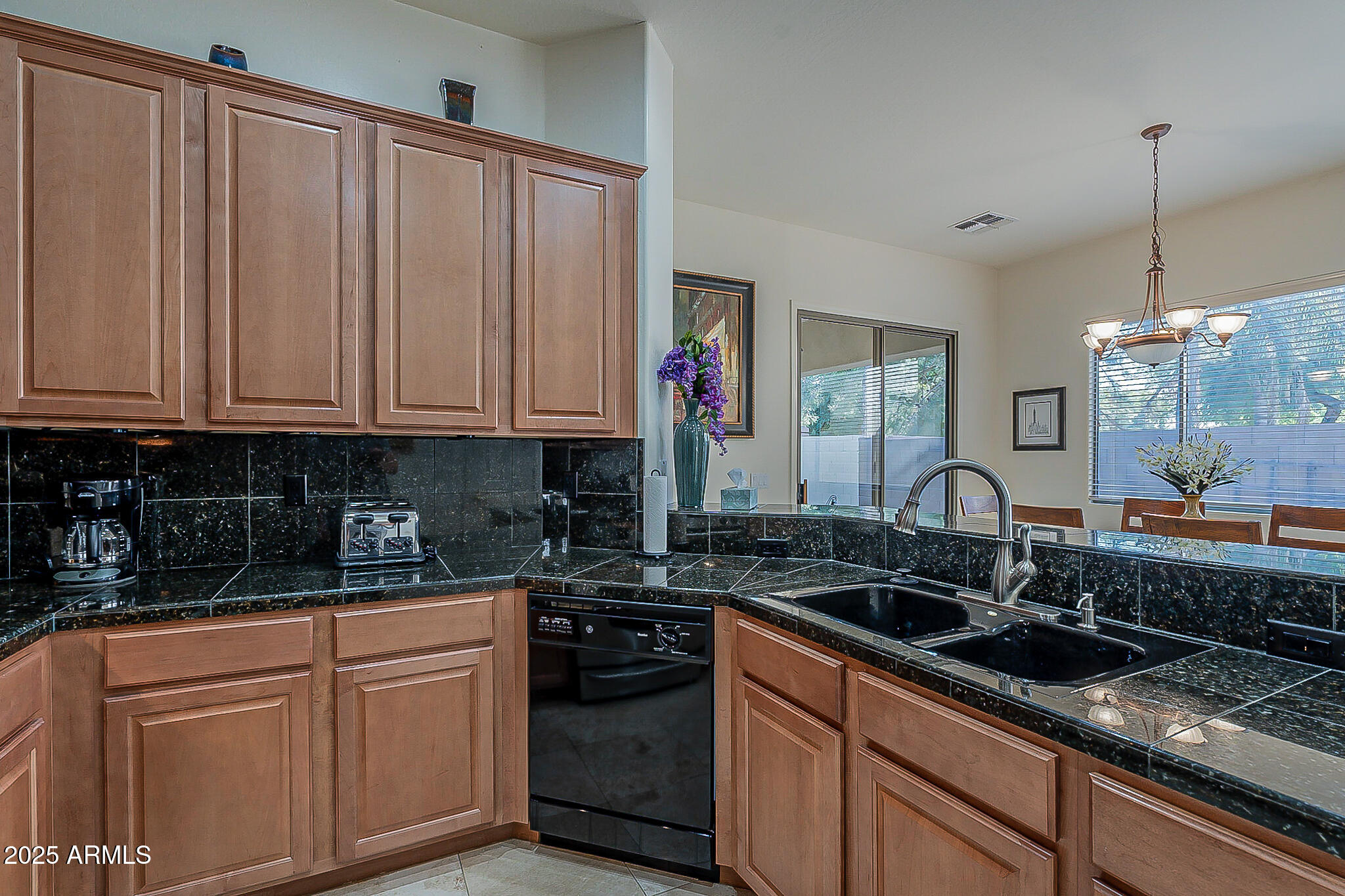 1857 West Periwinkle Way Chandler, AZ 85248 - Photo 10 of 38 a kitchen with stainless steel appliances granite countertop a sink stove and cabinets