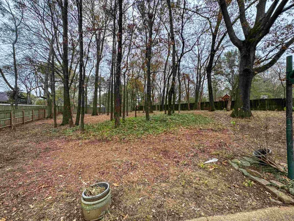 a backyard of a house with lots of trees