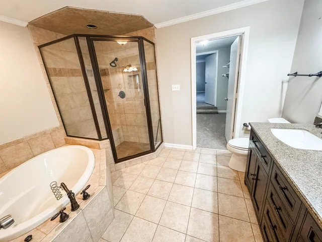 a bathroom with a granite countertop sink a mirror and a shower