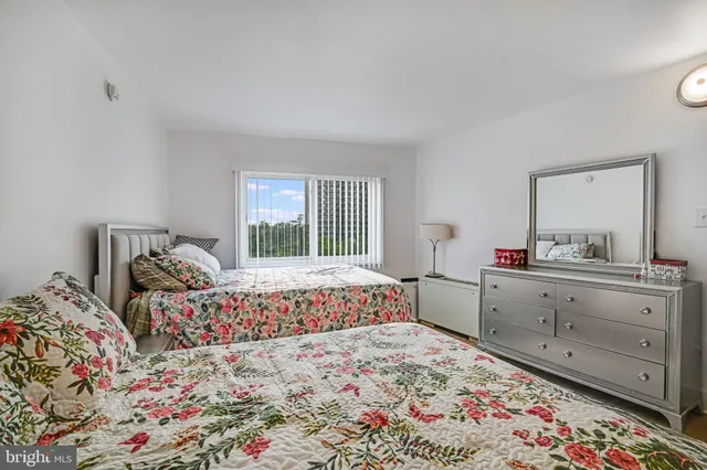 a bed room with a bed and a dresser