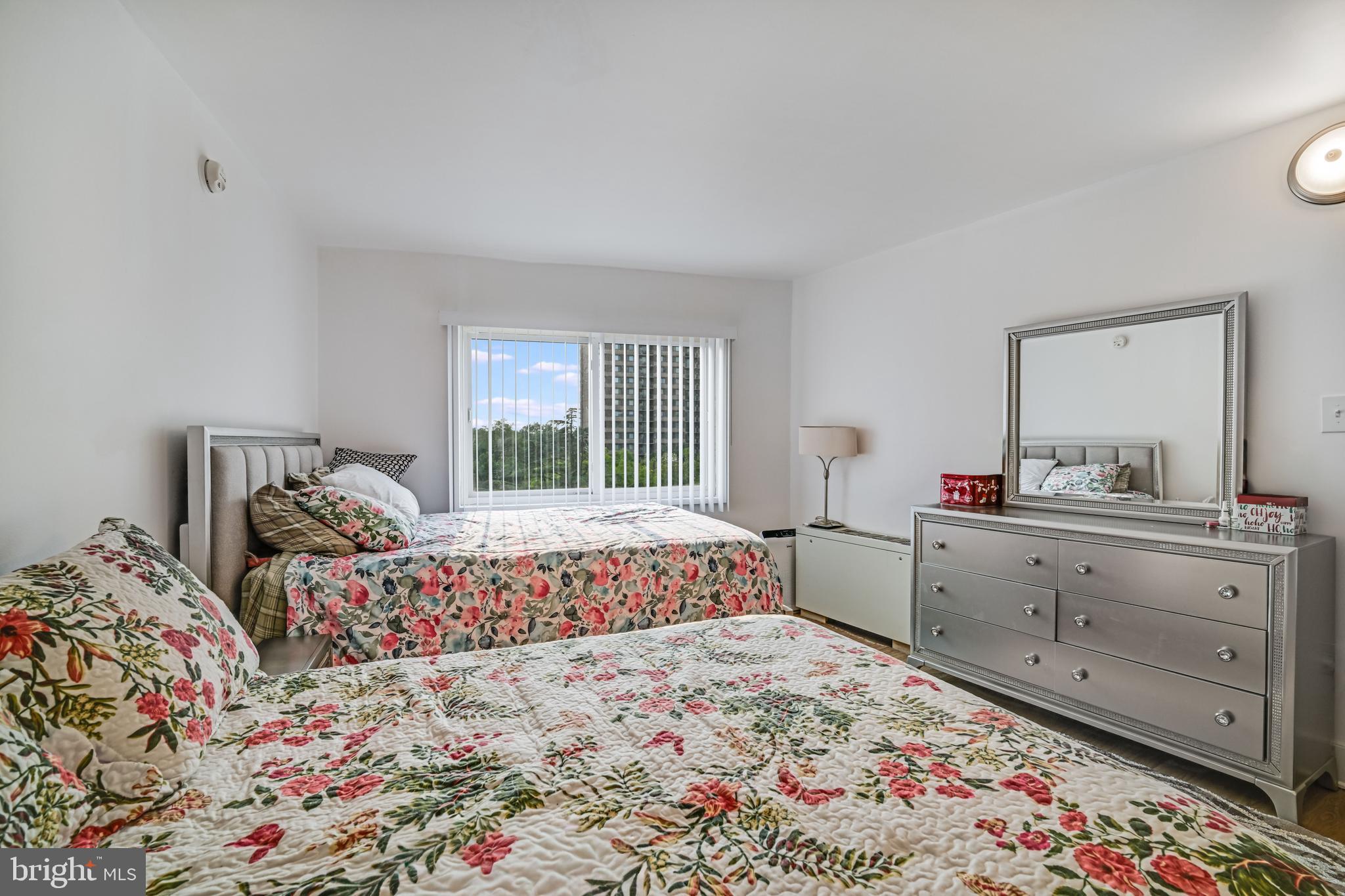 1111 University Boulevard West, Unit 611A Silver Spring, MD 20902 - Photo 11 of 30 a bed room with a bed and a dresser