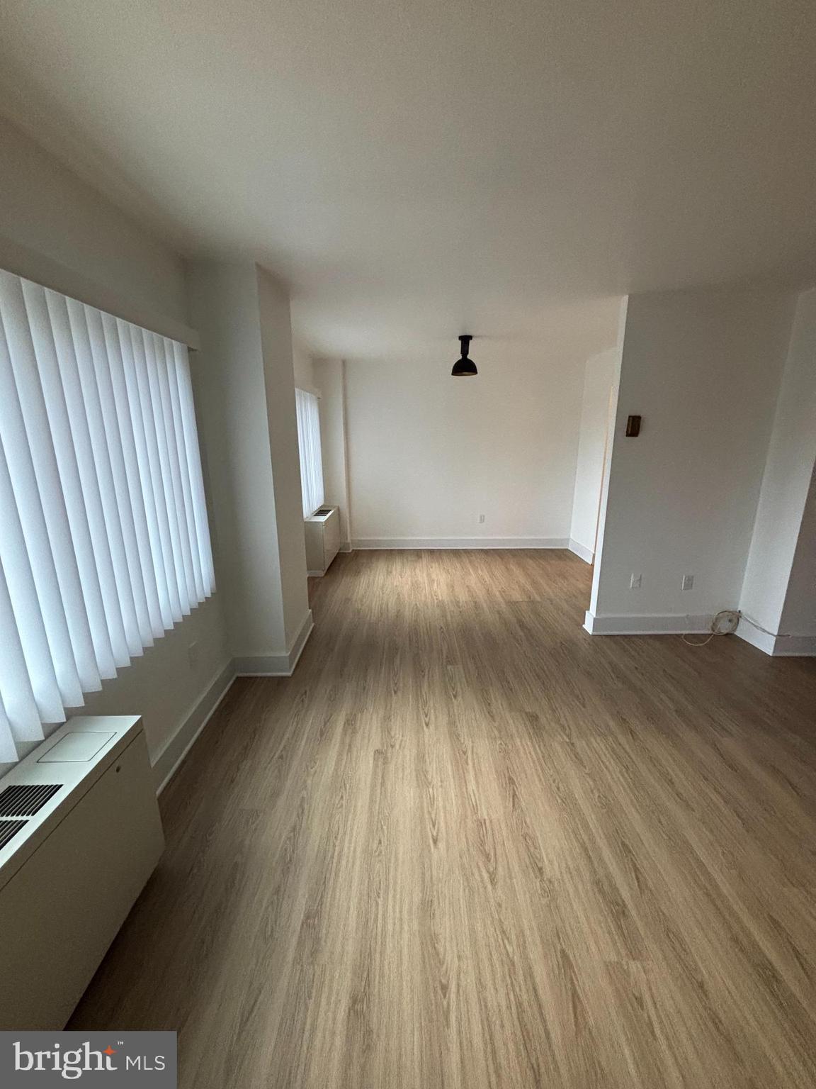 1111 University Boulevard West, Unit 611A Silver Spring, MD 20902 - Photo 14 of 30 wooden floor in an empty room with a window