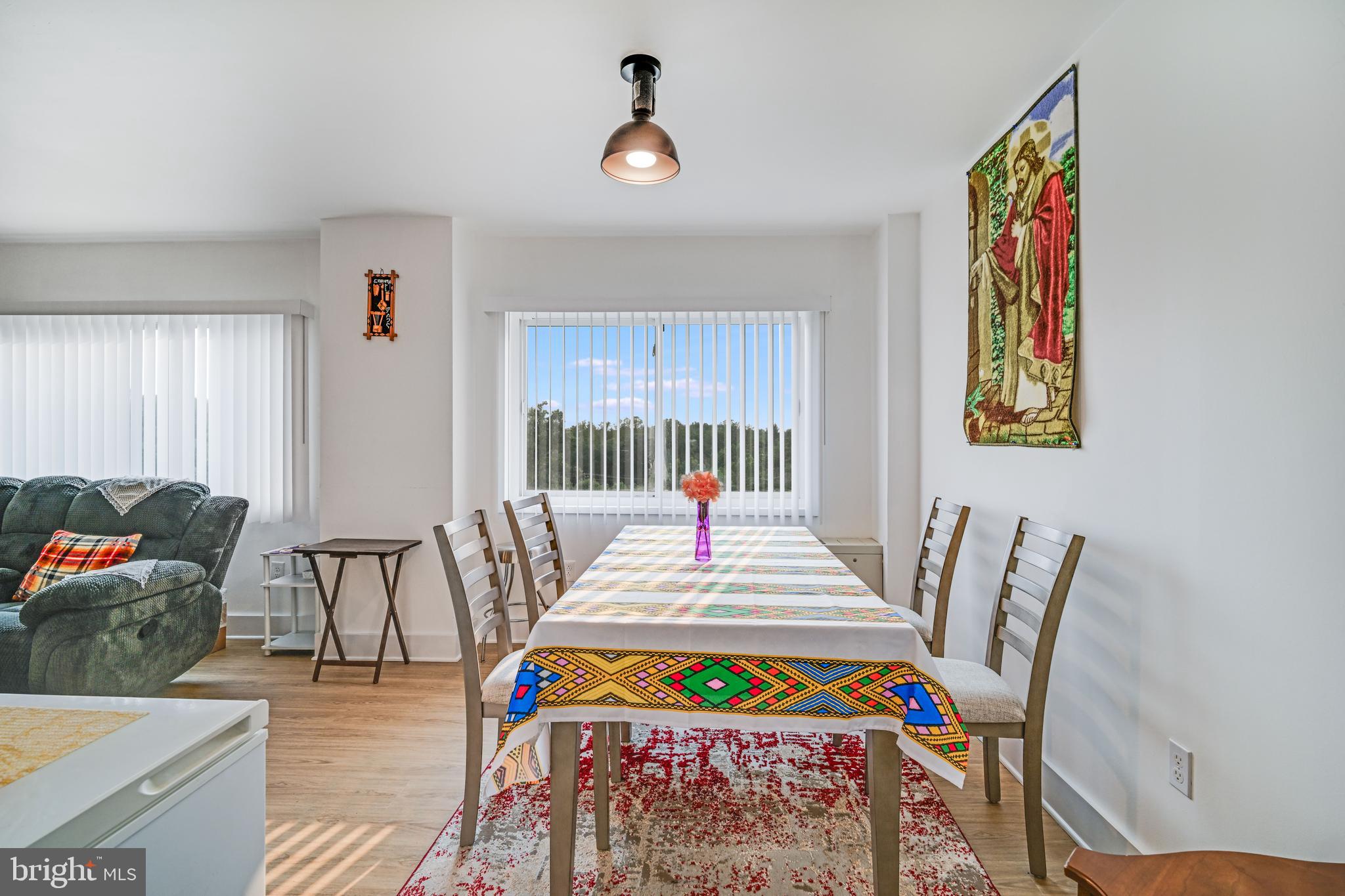 1111 University Boulevard West, Unit 611A Silver Spring, MD 20902 - Photo 15 of 30 a bedroom with a bed and wooden floor
