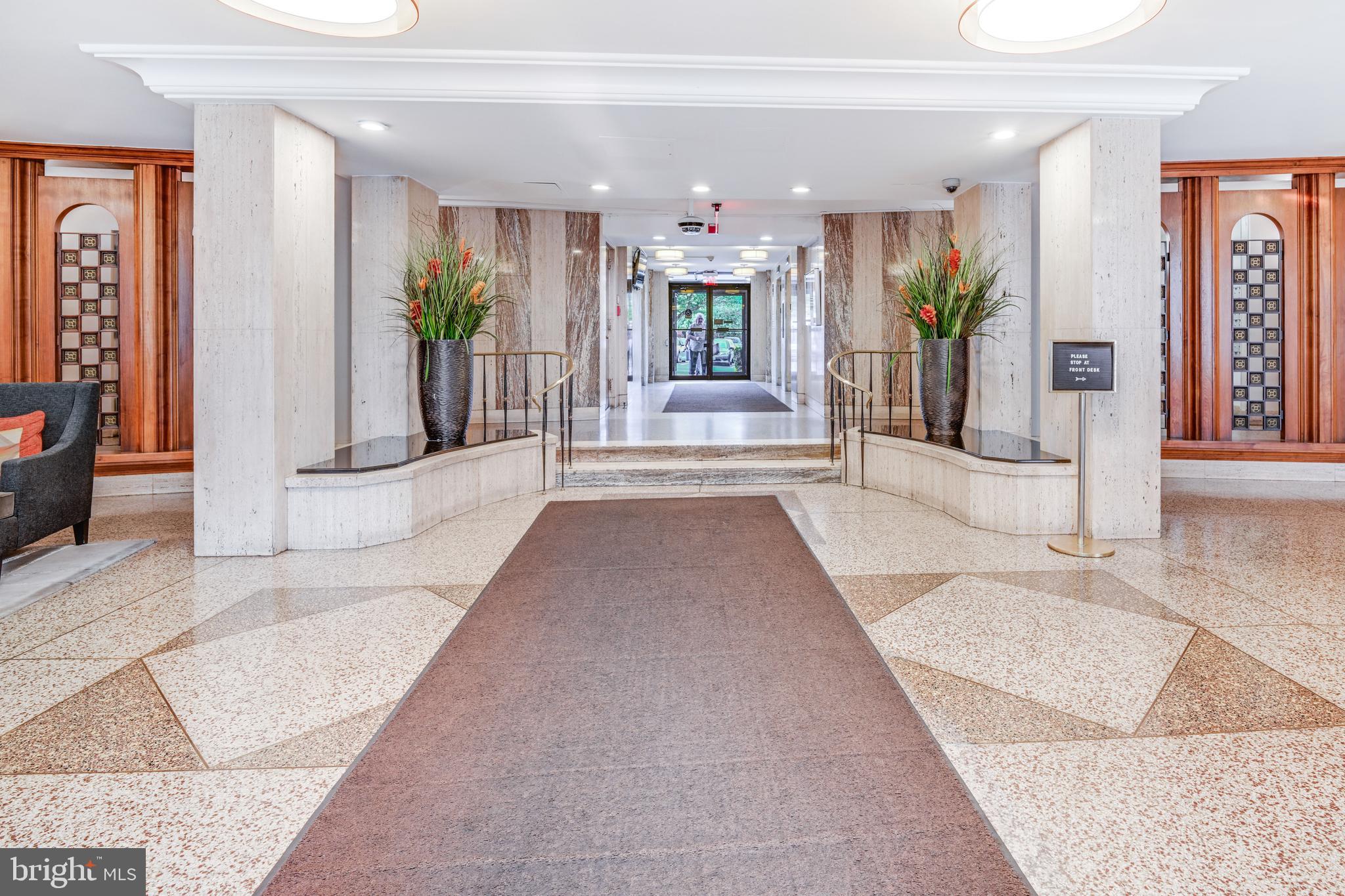 1111 University Boulevard West, Unit 611A Silver Spring, MD 20902 - Photo 22 of 30 a view of a hallway with dining area and chandelier