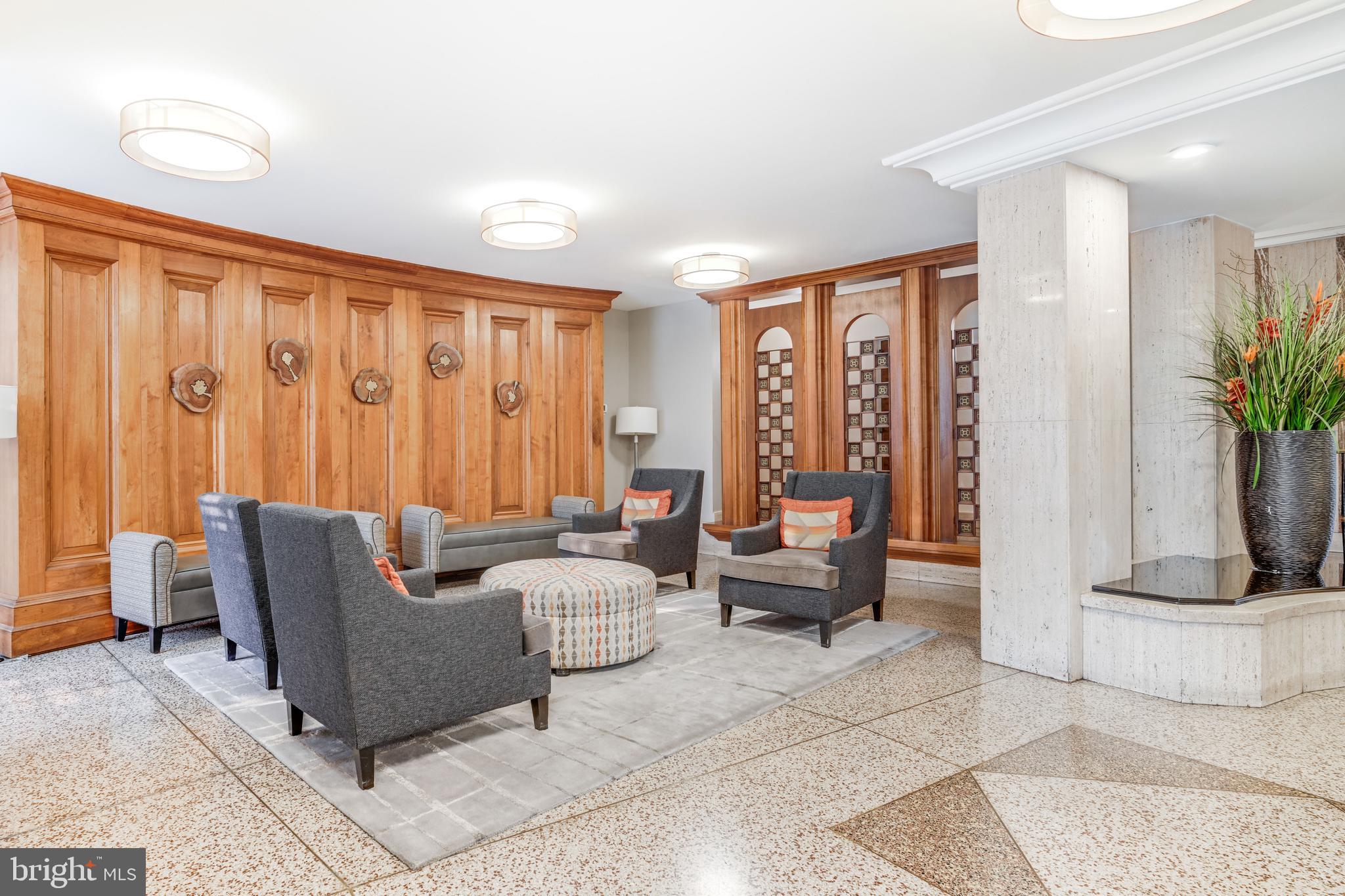 1111 University Boulevard West, Unit 611A Silver Spring, MD 20902 - Photo 23 of 30 a living room with furniture and a potted plant