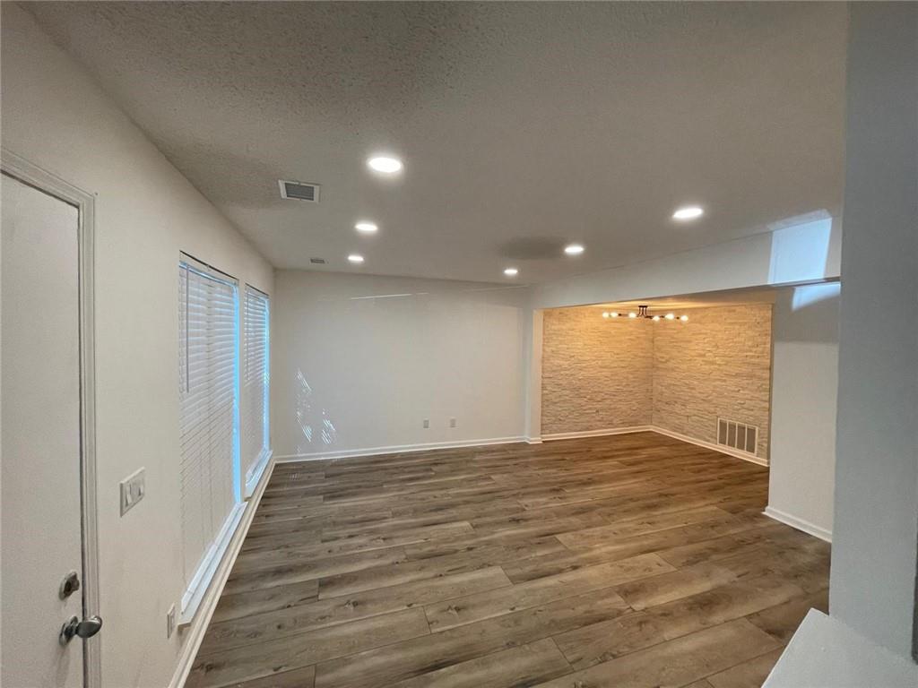 4416 Chowning Way Atlanta, GA 30338 - Photo 3 of 17 a view of an empty room with wooden floor and a window