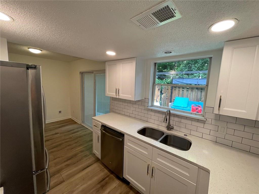 4416 Chowning Way Atlanta, GA 30338 - Photo 4 of 17 a kitchen with stainless steel appliances a sink a stove and a refrigerator