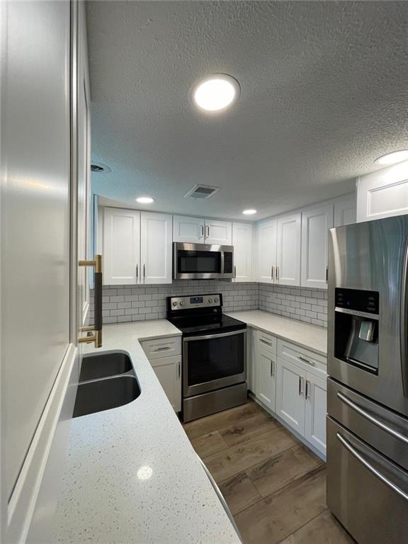4416 Chowning Way Atlanta, GA 30338 - Photo 7 of 17 a kitchen with stainless steel appliances kitchen island granite countertop a sink and a stove