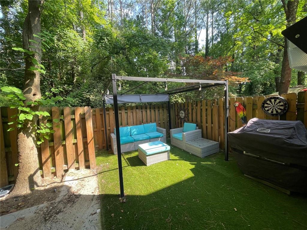 4416 Chowning Way Atlanta, GA 30338 - Photo 8 of 17 a view of a backyard with wooden fence and a bench