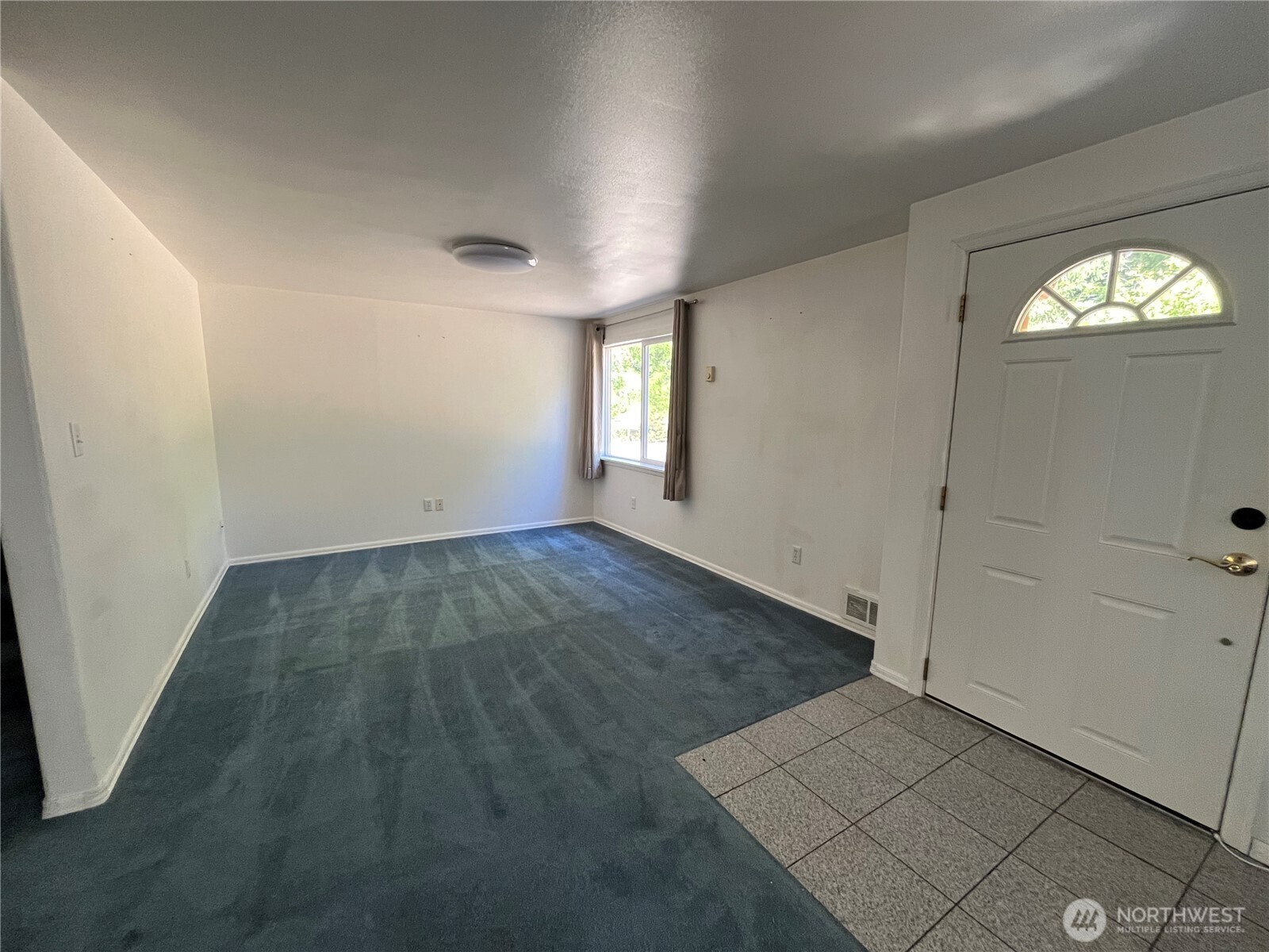 80 Southeast Channel Point Road Shelton, WA 98584 - Photo 6 of 26 an empty room with wooden floor and windows