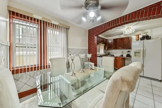 a view of a dining room with furniture a chandelier and wooden floor